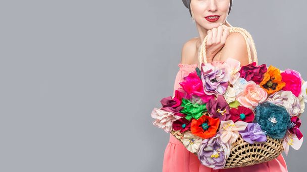 Beautiful woman with flowers on a bag - Foto, immagini