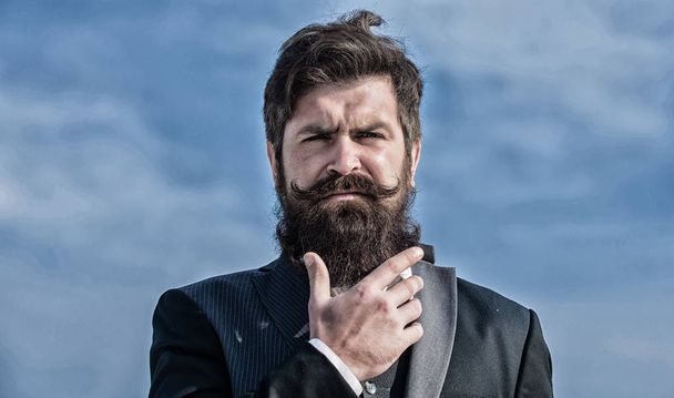 Bearded man. Future success. Male formal fashion. brutal caucasian hipster with moustache. Businessman against the sky. Mature hipster with beard. Bearded man touch beard. Man with beard outdoor - Φωτογραφία, εικόνα