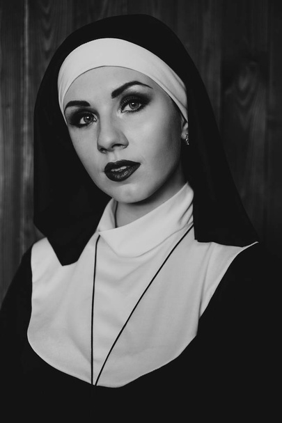 Sexy nun prays indoor. Beautiful young holy sister. - Photo, Image
