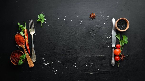The background of cooking. On a black wooden background. Top view. Free space for your text. - Фото, зображення