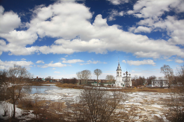 Ice drift on the river in Russia, the church on the shore - Фото, изображение