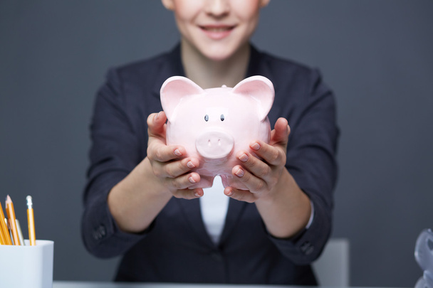 Showing piggy bank - Photo, Image