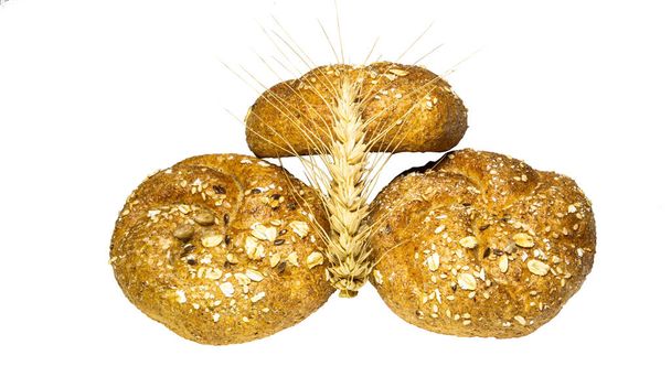 Freshly baked delicious three loafs of bread with a spikelet of  - Photo, Image