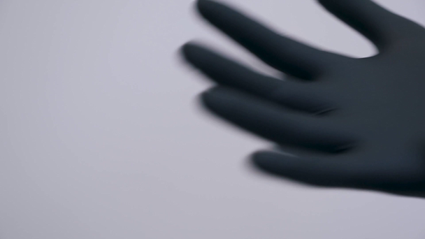 dressing up black latex gloves close up - Materiaali, video