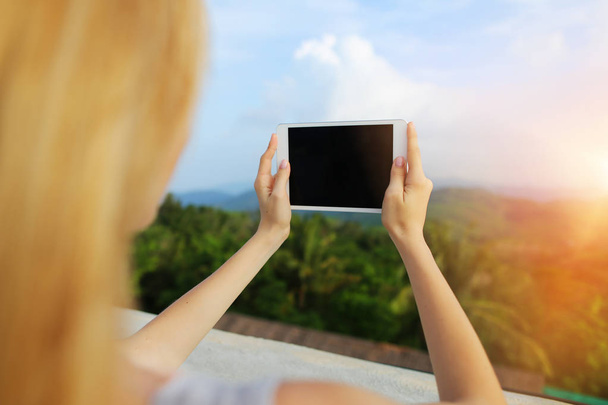 Sunshine photo of woman using tablet and taking photo of Thailand mountains. - Photo, Image