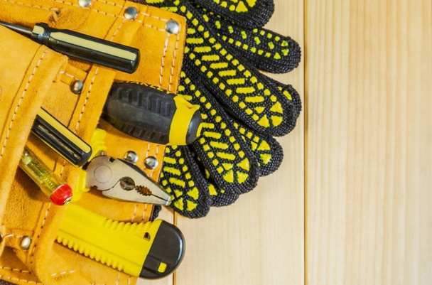 A necessary set of tools in a bag on a wooden background. - 写真・画像