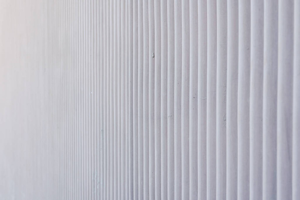 Wavy metal background on a gray wall. - Foto, afbeelding