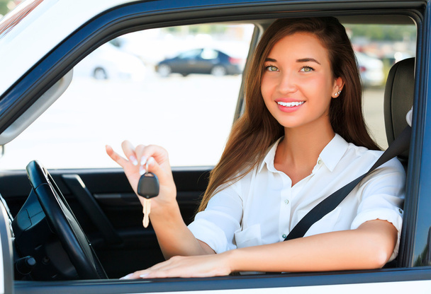 Pretty girl showing the car key - Photo, Image