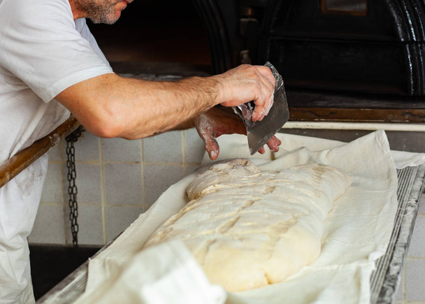 Production of baked bread with a wood oven in a bakery. - Φωτογραφία, εικόνα