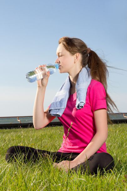 Tired woman drinking water after training - Photo, Image