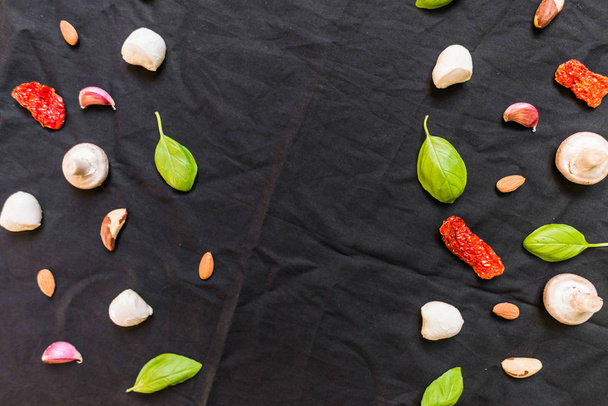 Selection of different Italian food ingredients against black background - Photo, Image