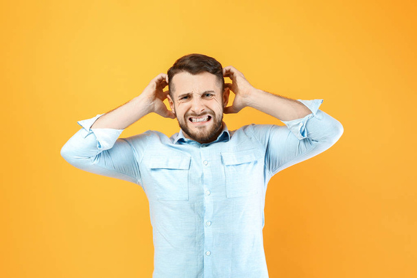 Stressed man on color background - Photo, Image