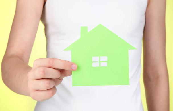 Paper house in hand on green background - Foto, Imagem
