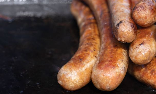 Closeup image of cooked sausages at an Australian election barbe - Photo, Image