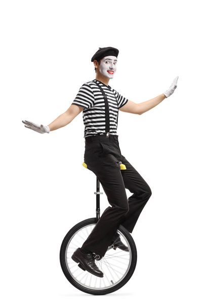 Mime riding a unicycle and making a grimace - Zdjęcie, obraz