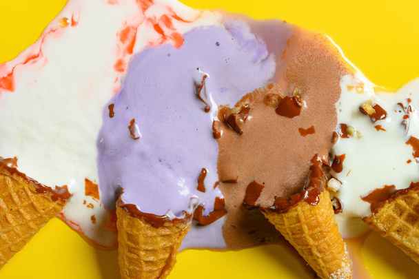 top view multiple flavor ice cream cones melted close up on yellow background - Фото, изображение
