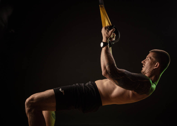 guy posing and practicing on TRX - Photo, Image