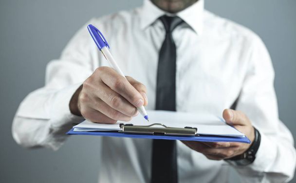 Businessman writing on empty paper. Business concept - Photo, Image