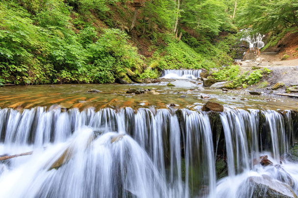 Picturesque and beautiful cascade waterfall of a mountain river in the Carpathians. - Foto, imagen