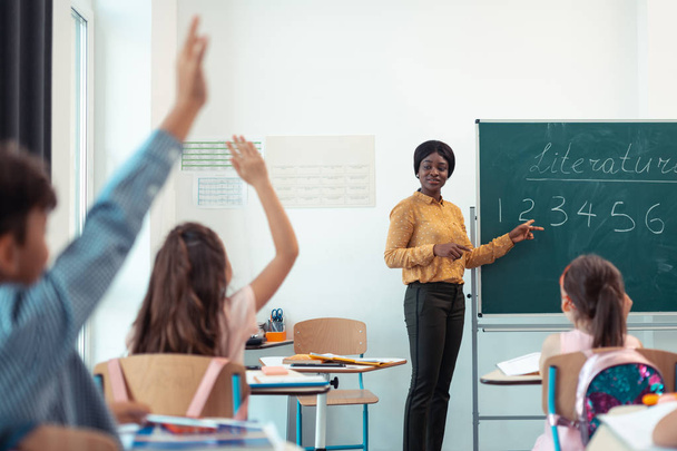 Темнокожая учительница задаёт вопрос своим умным ученикам
 - Фото, изображение