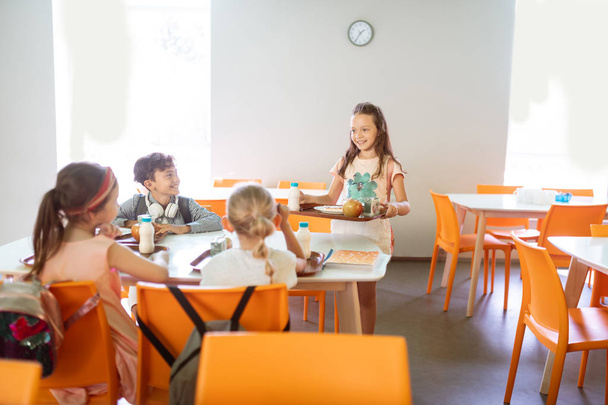 Cute good-looking children having lunch at school together - Photo, Image