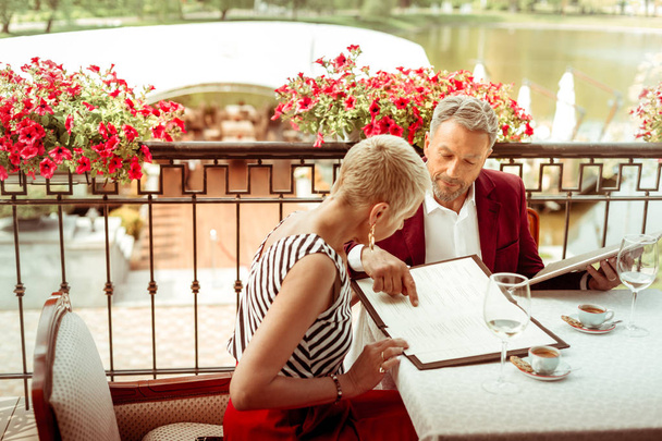 Husband and wife looking at the menu while coming to restaurant - Photo, Image