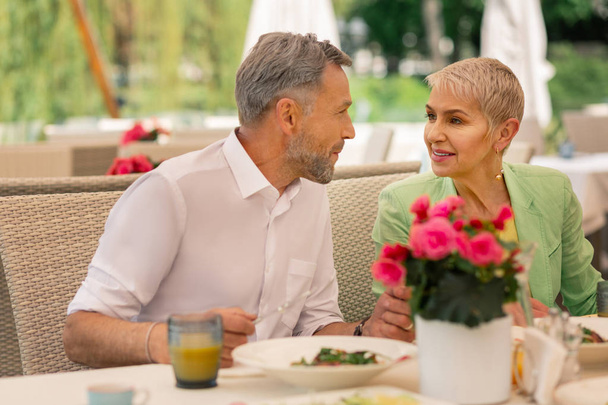Loving grey-haired mature man looking at his beautiful wife - Foto, imagen