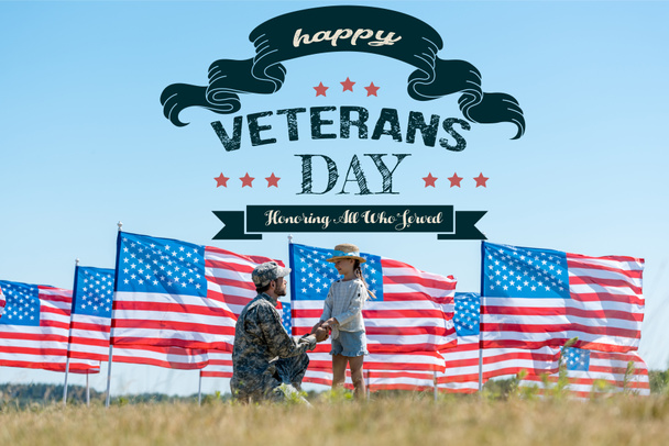selective focus of military father holding hands with cute kid near american flags with happy veterans day, honoring all who served illustration  - Φωτογραφία, εικόνα