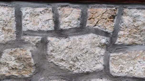 Texture of a stone wall. Old castle stone wall texture background. Stone wall as a background or texture. Part of a stone wall, for background or texture - Felvétel, videó