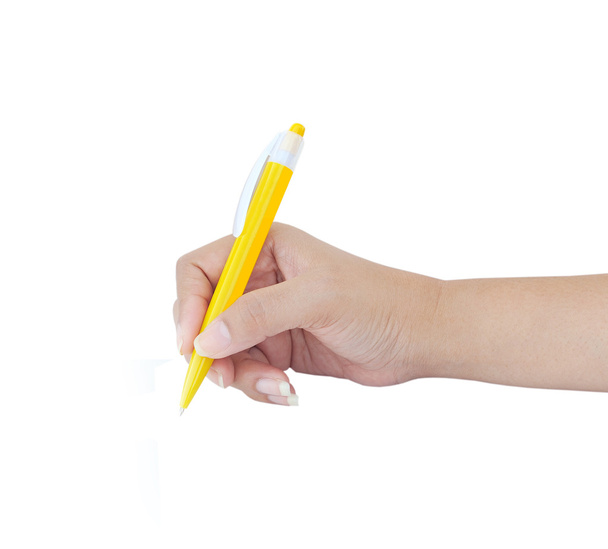 Female hand with yellow pen over white background - Foto, afbeelding