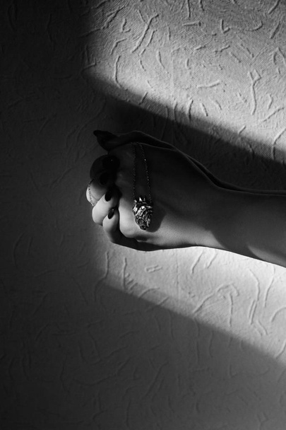 Woman hands holding silver heart shape pendant - Photo, Image