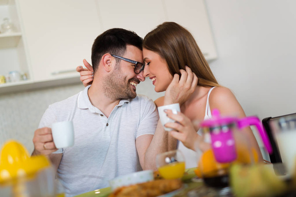 Happy couple enjoying breakfast time together at home. - Photo, Image