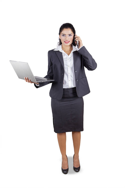 Indian businesswoman with laptop and phone - Photo, Image
