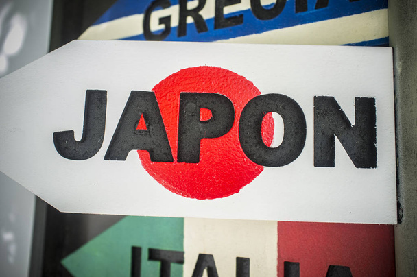 Pole guidepost with Japan sign and flag as background - Photo, Image