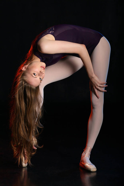 Stylish portrait of young ballerina. Beauty woman posing on black studio background  - Foto, Bild