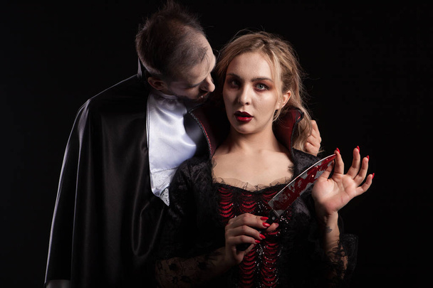 Portrait of a beautiful couple in medieval costumes with vampire style make-up for halloween - Valokuva, kuva
