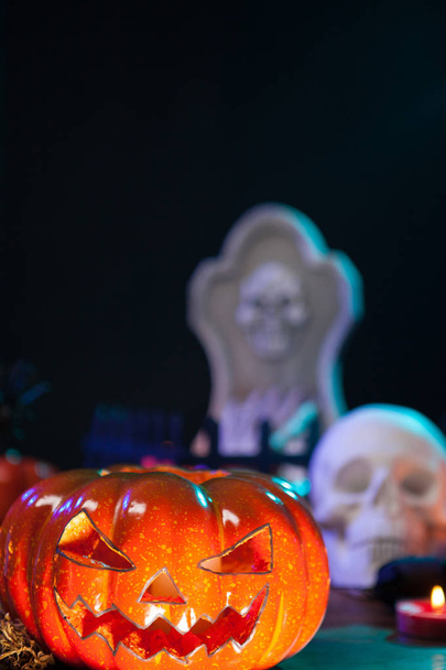 Scary halloween pumpking illuminated sitting on a wooden table - Fotoğraf, Görsel