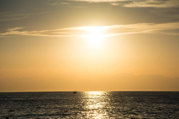 Delightful colors of sunset on the sea on the beach , azure coast, beautiful nature - 写真・画像