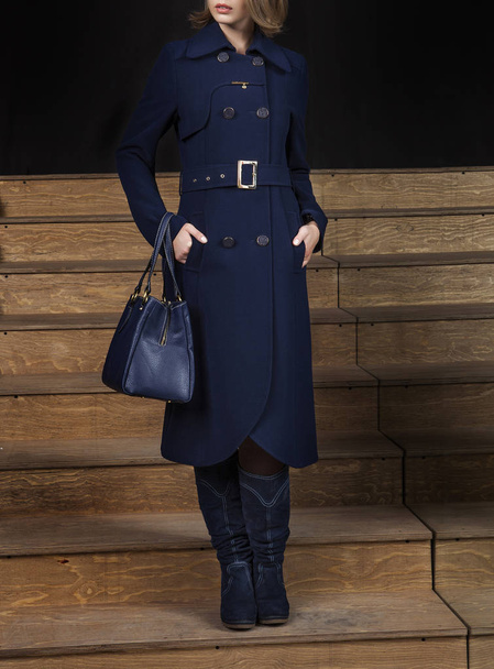 Female model in trendy blue coat, studio shot - Photo, Image