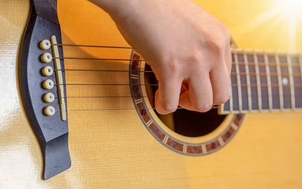 Guitar close up with fingers playing it - Photo, Image