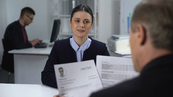 Female job candidate nervously waiting HR manager looking through resume - Footage, Video