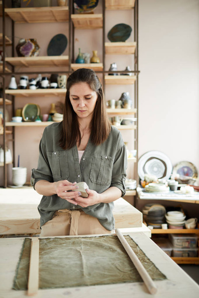 Waist up portrait of contemporary female artisan working in pottery studio - Fotografie, Obrázek