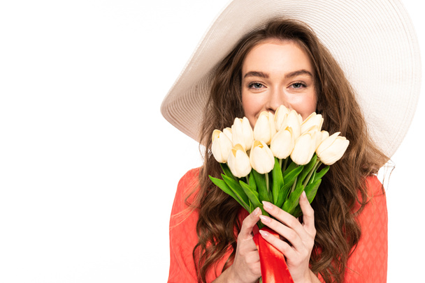 happy elegant woman in hat and dress holding tulips bouquet isolated on white - Foto, immagini