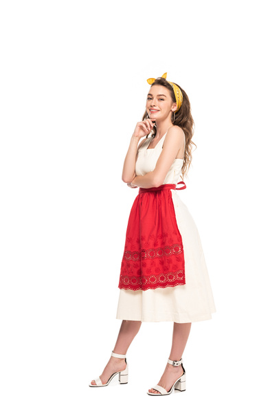 full length view of happy young housewife in dress and apron posing isolated on white - Foto, immagini