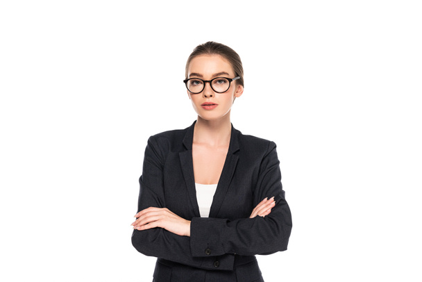 young successful businesswoman in black suit and glasses with crossed arms isolated on white - Foto, afbeelding