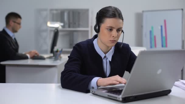 Nervous female call manager taking off headset and closing laptop, hard day - Metraje, vídeo