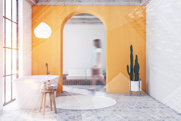 Woman in yellow bathroom and living room - 写真・画像
