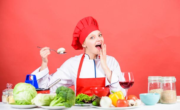 Cooking meal. Delicious recipe concept. Girl at kitchen table. Cooking food and housekeeping. Housewife routine. Cooking healthy food. Professional cooking tips. Woman chef try taste eat food - Φωτογραφία, εικόνα