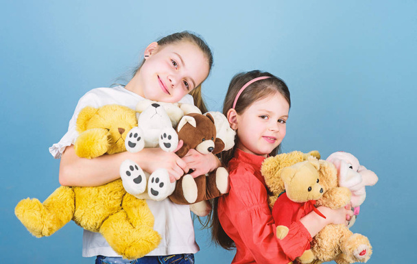 happy childhood. handmade. sewing and diy crafts. playground in kindergarten. toy shop. childrens day. small girls with soft bear toys. little sisters girls playing game in playroom. Playing together - Foto, Imagen