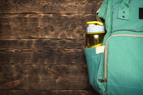 Sport flat lay background with a copy space. A backpack and yellow bottle of water. - Zdjęcie, obraz